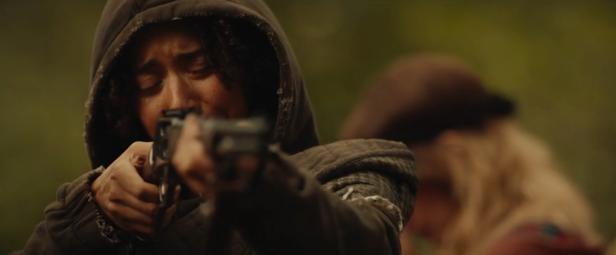 Tai holding a rifle